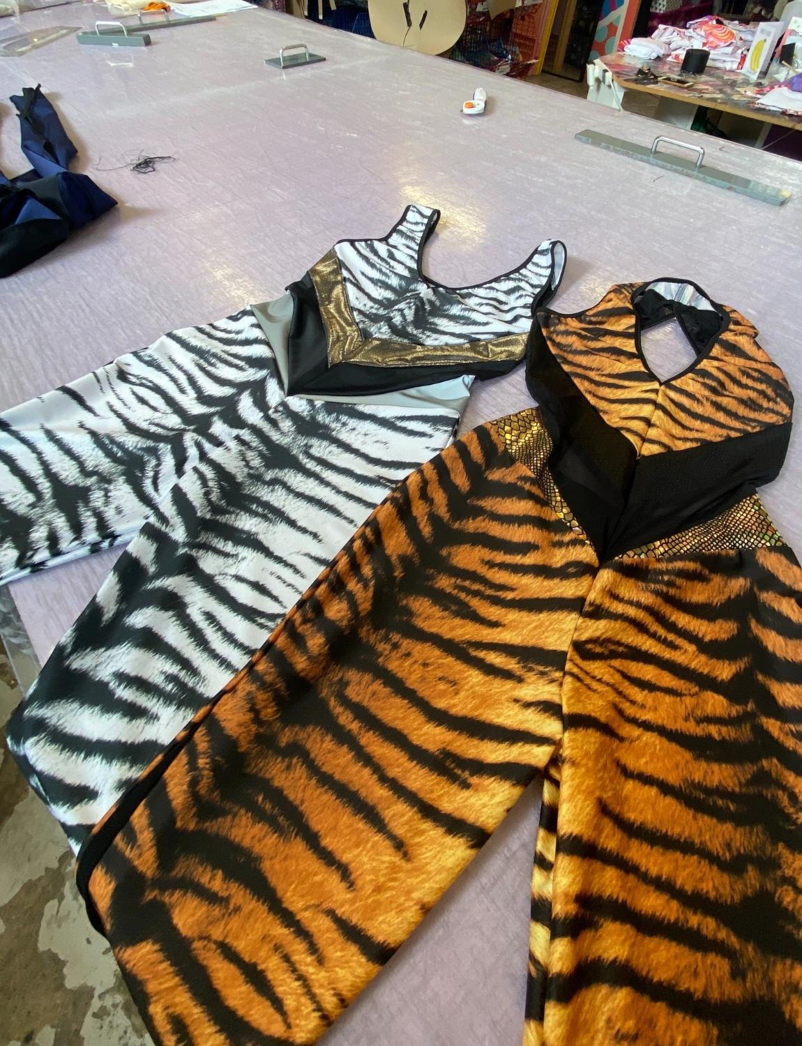 Burnt Soul custom catsuits in zebra and tiger fabric 