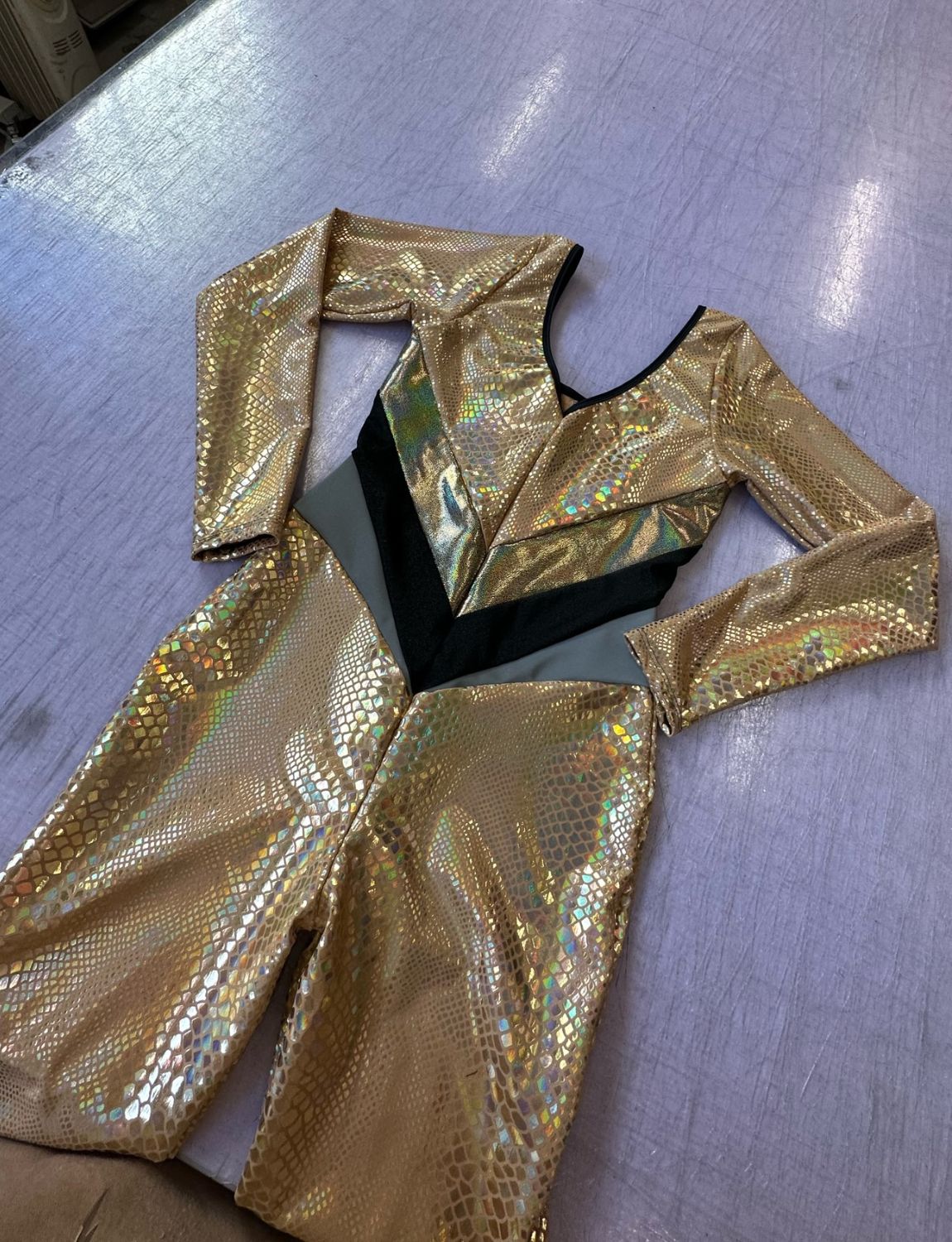 Burnt Soul custom peekaboo catsuit made of gold snake fabric 